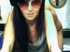 A thin harlot with dirty brunette hair flaunts her topless figure over a webcam.